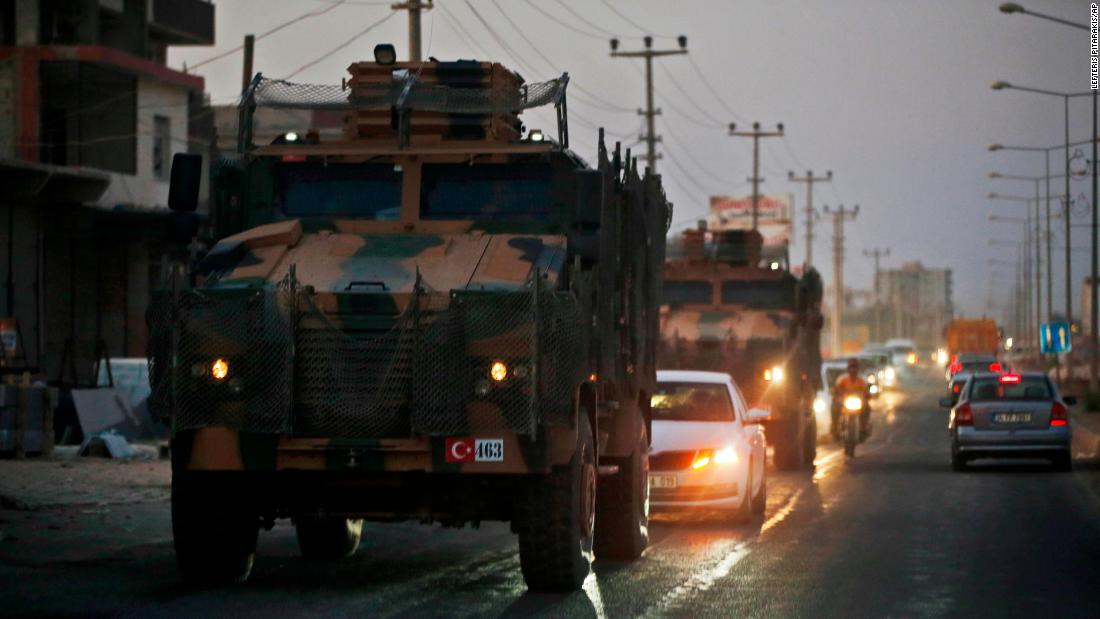 Turkish military vehicles drive through Akcakale, Turkey, near the border.