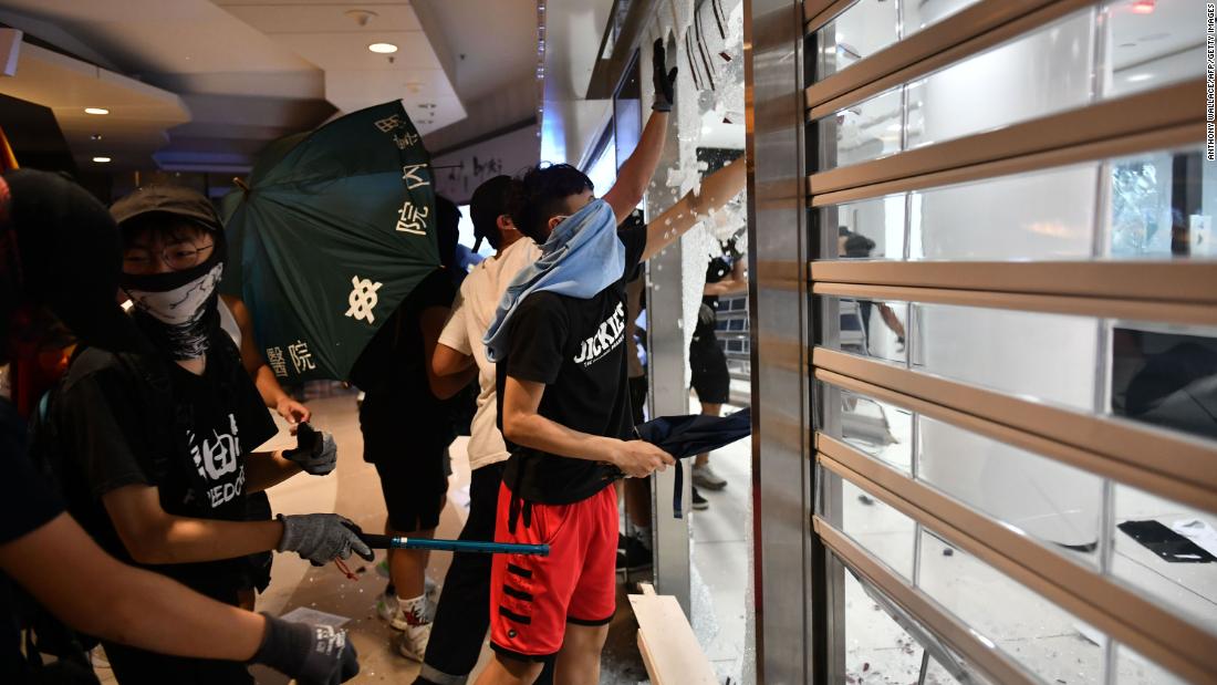 Protesters smash up a Bank of China branch on Monday, October 7.