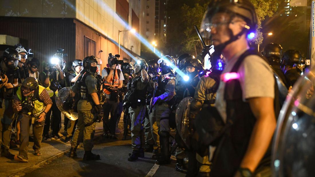 Police shine lights at protesters outside the Ma On Shan police station on October 9.