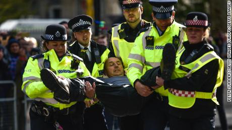 Police arrest an activist during Extinction Rebellion demonstrations on Whitehall on October 9.