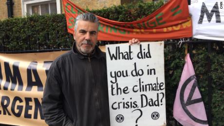 Andrew David Peel stands on a street near St James&#39;s Park holding a placard which, he says, sums up why he has become involved with the movement. 