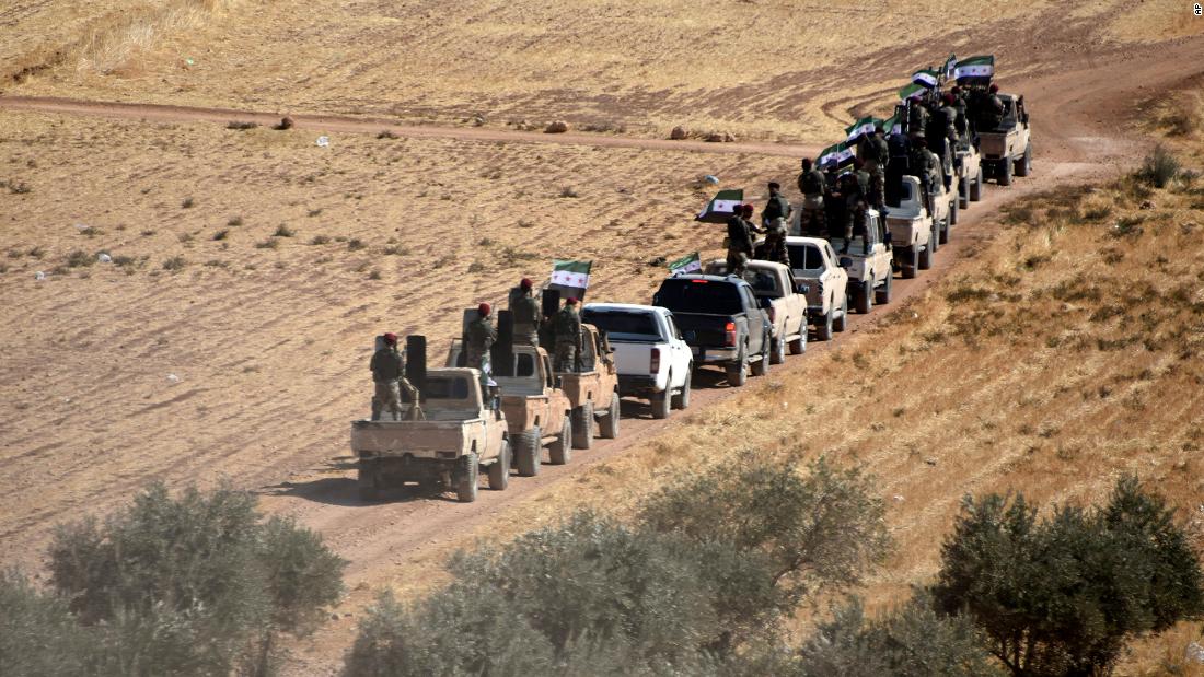 Turkish-backed fighters of the Free Syrian Army head toward Tal Abyad, Syria, on Thursday, October 10.