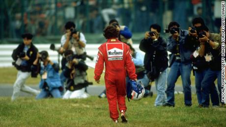 Alain Prost walks away from the scene of his collision with Ayrton Senna in 1989.