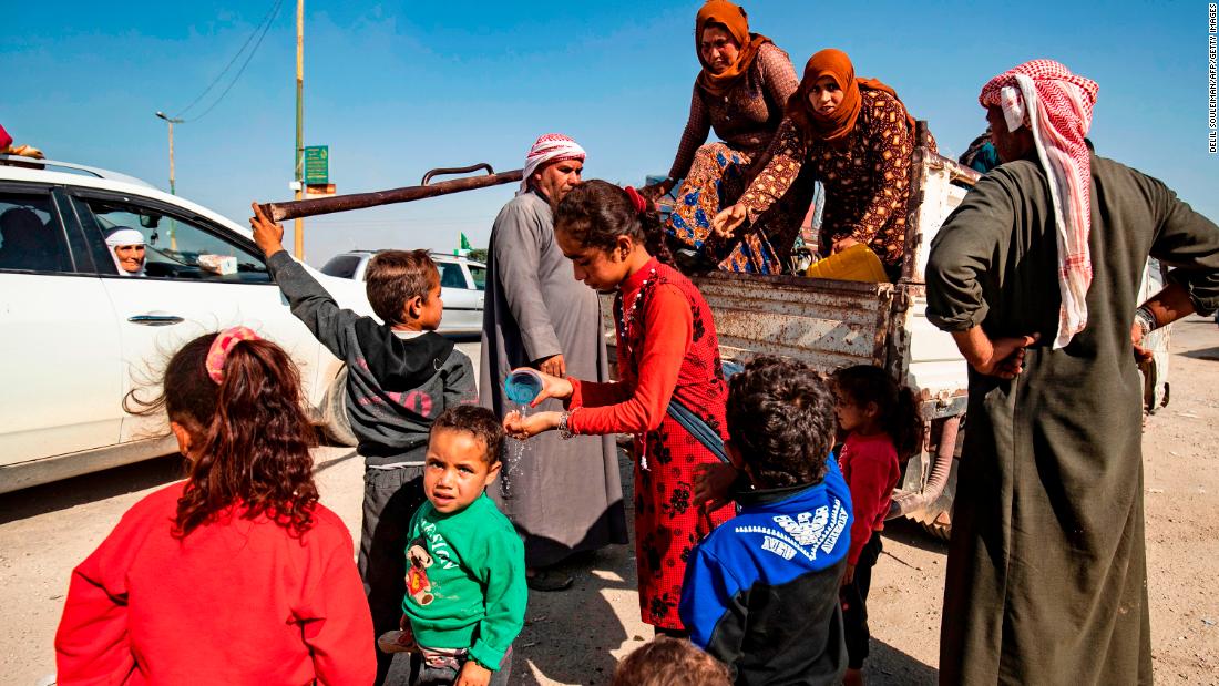 Refugees arrive in Tal Tamr, Syria, after fleeing the fighting on October 10.