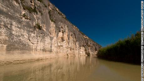 Rugged cliffs along the Rio Grande in Val Verde County, Texas, form a natural barrier between Mexico (right) and the US. 