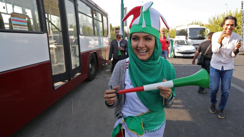 An Iranian woman wearing her country&#39;s national colours arrives at the Azadi stadium.