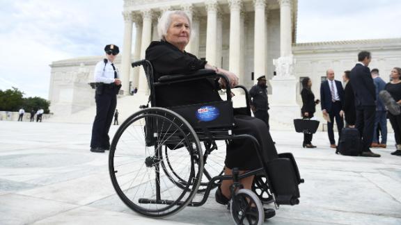 Transgender activist Aimee Stephens, sits in her wheelchair outside the US Supreme Court in Washington, DC, October 8, 2019, as the Court holds oral arguments in three cases dealing with workplace discrimination based on sexual orientation. - Thomas Rost, owner of RG & GR Harris Funeral Homes in Garden City, Michigan, is at the center of a US Supreme Court case involving allegations of transgender discrimination by a former employee. Born a boy 58 years ago, Aimee Stephens worked for the Detroit funeral home for six years before telling her employer she wanted to be issued a female uniform. Two weeks later, she was fired by her boss, Thomas Rost, who said: "This is not going to work." In defending his decision, Rost cited his Christian values and the need to avoid upsetting customers in mourning. (Photo by SAUL LOEB / AFP) (Photo by SAUL LOEB/AFP via Getty Images)