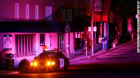 Police officers patrol a street during a power outage in Oakland, California.