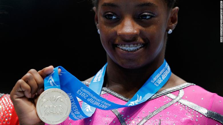 Biles poses after winning the gold medal in the floor exercise at the 2013 World Championships.