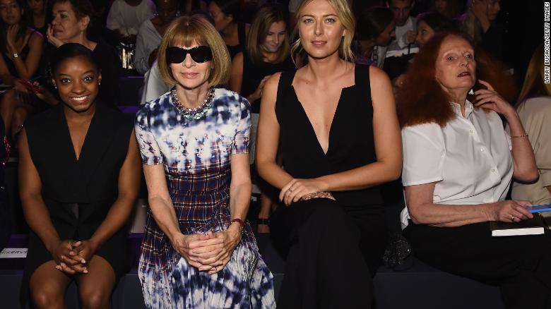 Biles sits with Anna Wintour and Maria Sharapova during New York Fashion Week in September 2016.
