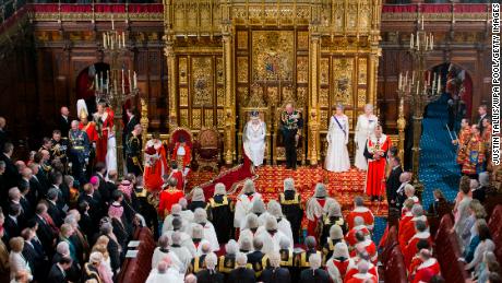LONDON, ENGLAND - MAY 18:  Queen Elizabeth II prepares to deliver the Queen&#39;s Speech from the throne as Prince Philip, Duke of Edinburgh looks on (R) and Prince Charles, Prince of Wales (L) and Camilla, Duchess of Cornwall arrive during State Opening of Parliament in the House of Lords at the Palace of Westminster on May 18, 2016 in London, England. The State Opening of Parliament is the formal start of the parliamentary year. This year&#39;s Queen&#39;s Speech, setting out the government&#39;s agenda for the coming session, is expected to outline policy on prison reform, tuition fee rises and reveal the potential site of a UK spaceport. (Photo by Justin Tallis - WPA Pool/Getty Images)