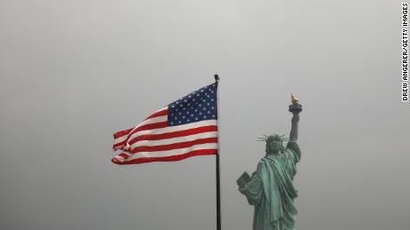 An America flag flies near the Statue of Liberty on Liberty Island on August 14, 2019 in New York City. 