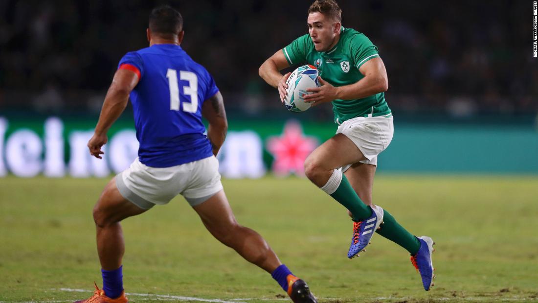 Jordan Larmour of Ireland runs with the ball towards Alapati Leiua of Samoa. The game took place in the west of Japan as a typhoon battered Tokyo some 1,100 kilometers away. 