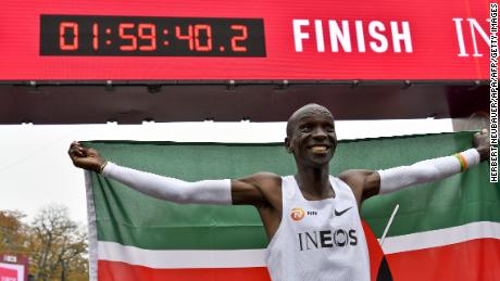 Kenya&#39;s Eliud Kipchoge (white jersey) celebrates after busting the mythical two-hour barrier for the marathon on October 12 2019 in Vienna. - Kipchoge holds the men&#39;s world record for the distance with a time of 2hr 01min 39sec, which he set in the flat Berlin marathon on September 16, 2018.
He tried in May 2017 to break the two-hour barrier, running on the Monza National Autodrome racing circuit in Italy, failing narrowly in 2hr 00min 25sec. (Photo by HERBERT NEUBAUER / APA / AFP) / Austria OUT (Photo by HERBERT NEUBAUER/APA/AFP via Getty Images)