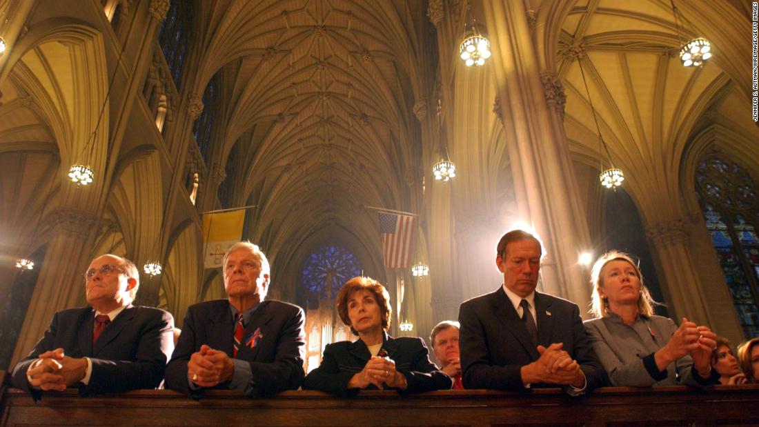 Giuliani, left, prays at St. Patrick&#39;s Cathedral a few days after the September 11 attacks. At right is New York Gov. George Pataki and his wife, Libby.