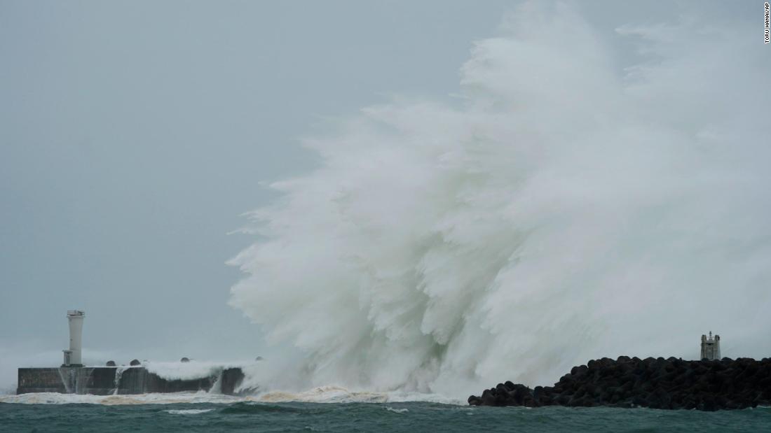 Surging waves hit against the breakwater in Kiho, Japan, on October 12.