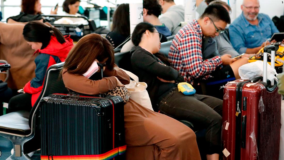 People sleep at the Haneda Airport in Tokyo on October 12. Flights were canceled on Saturday as Typhoon Hagibis approached the coast of Japan.