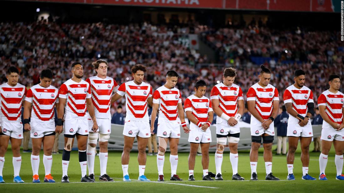 Japan&#39;s players line up for a minute of silence for the victims of Typhoon Hagibis prior to their match against Scotland. At least 15 people were killed and 140 are missing after Japan&#39;s worst storm in decades.