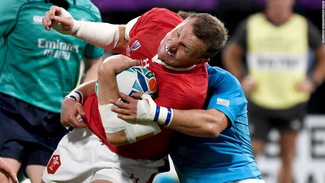 Wales&#39; centre Hadleigh Parkes is tackled.