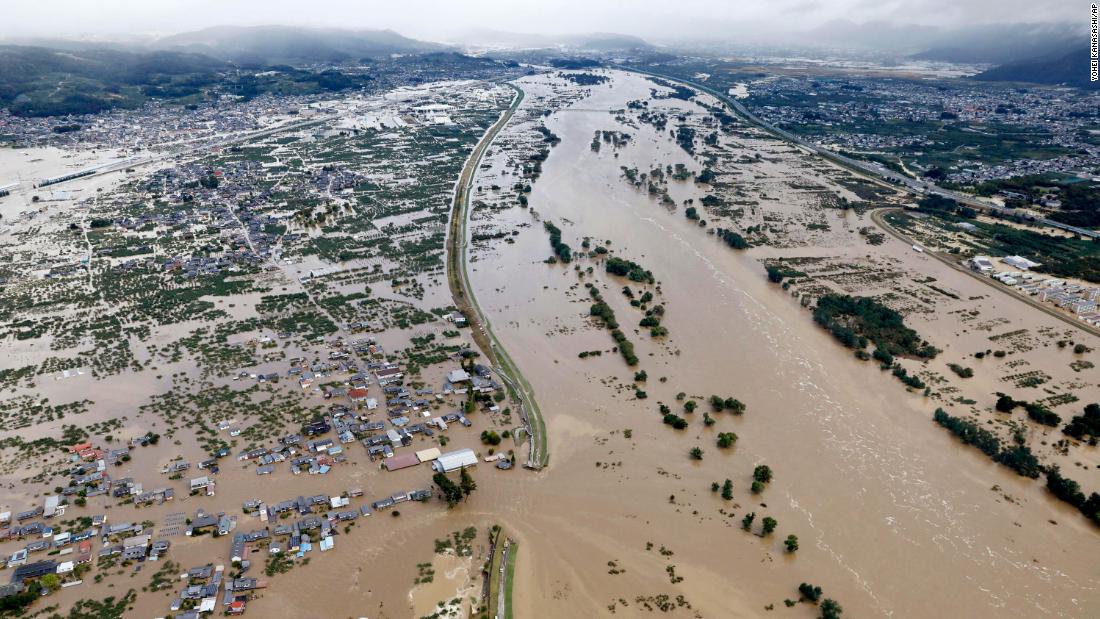 Residential areas are submerged in muddy waters after an embankment of the Chikuma River broke in Nagano, Japan, on October 13. 