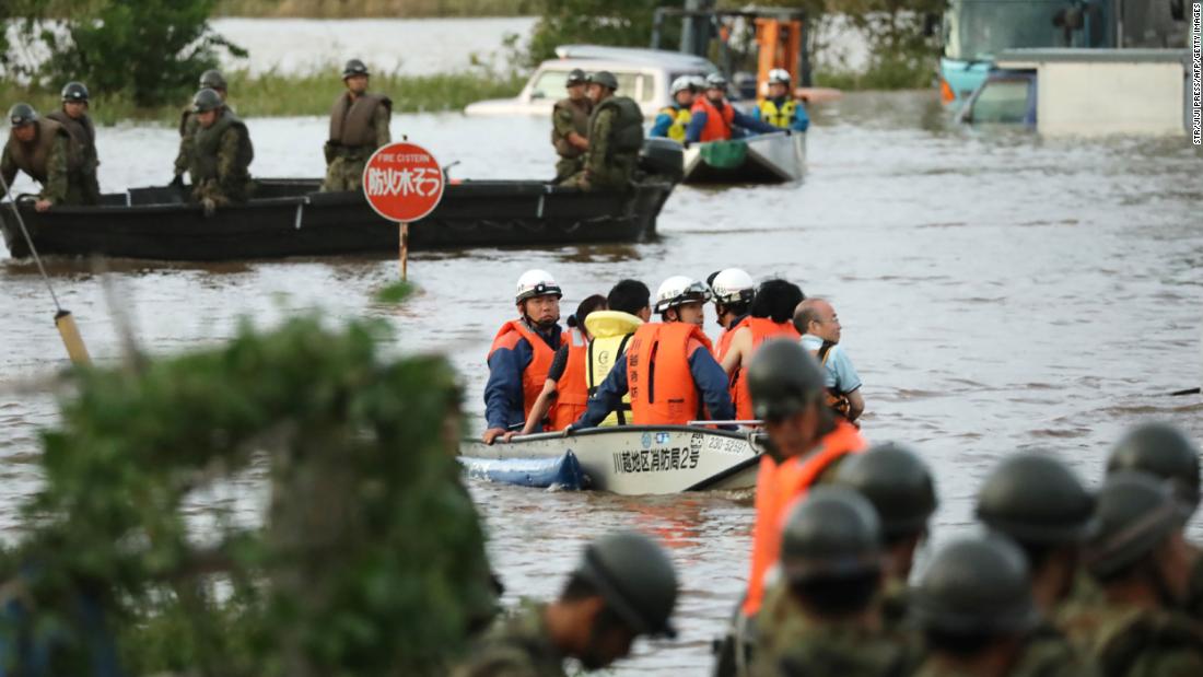 Fire department workers evacuate residents from a flooded area in Kawagoe, Japan, on October 13. 