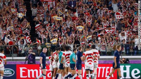 Japan supporters celebrate their team&#39;s third try  during the Japan 2019 Rugby World Cup Pool A match between Japan and Scotland at the International Stadium Yokohama in Yokohama on October 13, 2019. (Photo by Odd ANDERSEN / AFP) (Photo by ODD ANDERSEN/AFP via Getty Images)