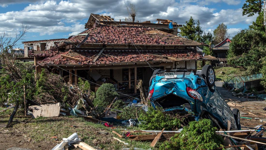 An upturned car lies next to a partially destroyed house after being hit by a tornado shortly before the arrival of Typhoon Hagibis, on October 13 in Chiba, Japan. 