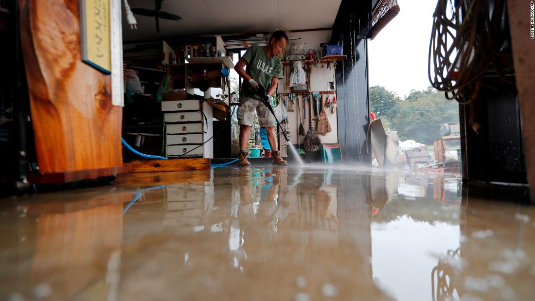 A volunteer helps clean up Monday, October 14, 2019, in Kawagoe City, Japan. 