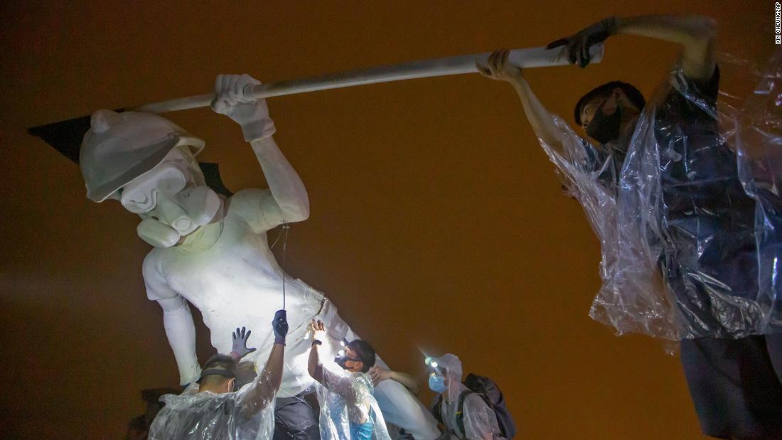 Anti-government protesters set up "The Lady Liberty of Hong Kong" statue, which symbolizes the city's recent democratic movement. The figure stands a little over 13 feet tall and was carried in pieces to the top of Lion Rock, one of Hong Kong's iconic peaks.