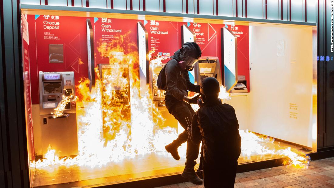 Protesters set fire to a Bank of China branch on Sunday, October 13. It was the 19th consecutive weekend of anti-government protests in Hong Kong.