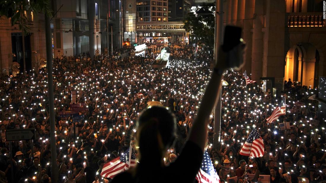 Protesters use the lights on their phones during a rally in central Hong Kong&#39;s business district.