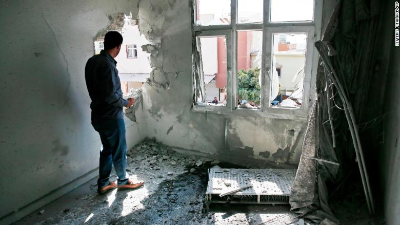 A person inspects the damage from a mortar fired from inside Syria, in Akcakale, southeastern Turkey, on Sunday.