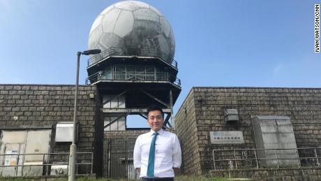 Ray Kong, a scientific officer at the Hong Kong Observatory, in front of the Tai Mo Shan weather radar. It is perched atop Hong Kong&#39;s tallest peak.