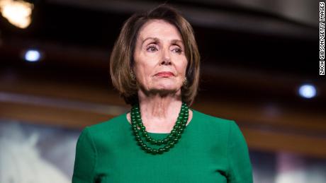 House Speaker Nancy Pelosi listens during a news conference on Tuesday, October 15 in Washington.