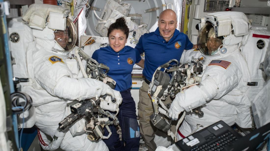 NASA astronauts Andrew Morgan (left) and Christina Koch (right) are suited up in US spacesuits, assisted by NASA Flight Engineer Jessica Meir and European Space Agency Commander Luca Parmitano.