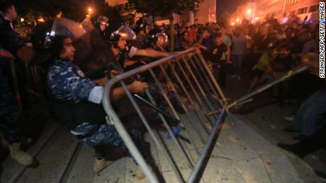 Demonstrators clash with police on October 17, 2019 outside the government palace in Beirut. 