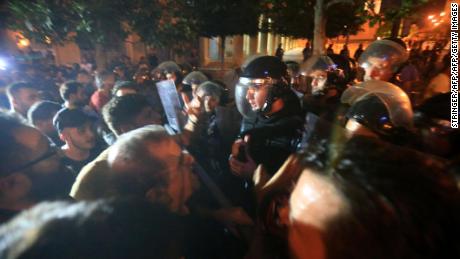 Demonstrators clash with police outside the government palace in Beirut. 