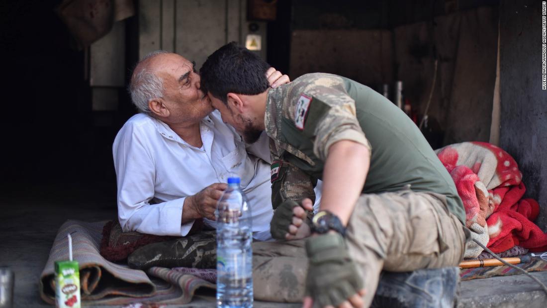 A local resident of Ras al-Ain kisses the forehead of a member of the Turkish-backed Free Syrian Army on October 17. 