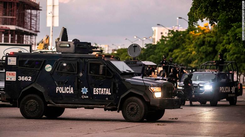 Mexican police patrol in a street of Culiacan after heavily armed gunmen fought an intense battle with Mexican security forces. 