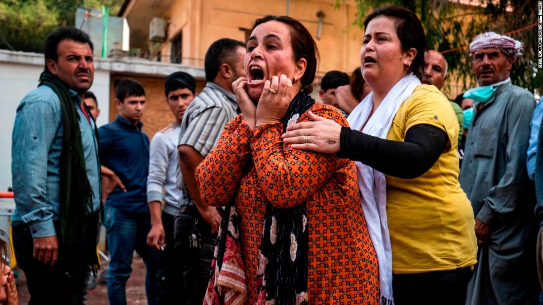 A woman reacts as a man&#39;s dead body arrives at a hospital in Ras al-Ain on October 18.