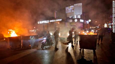 Lebanese security forces move dumpsters to open up the main Beirut-Tripoli highway, near the town of Kaslik north of the Lebanese capital.