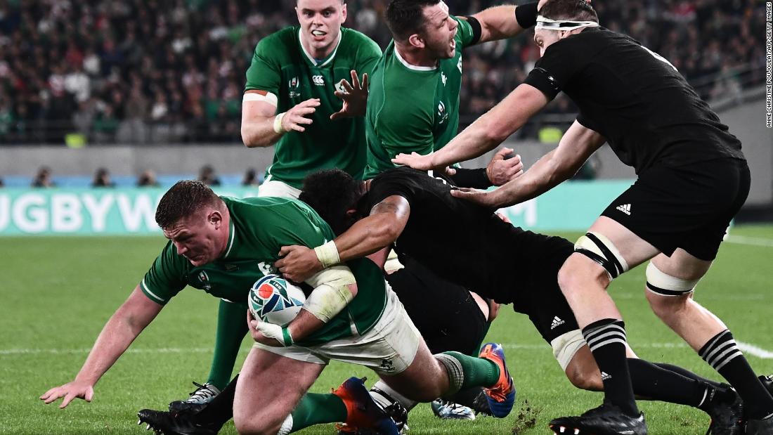 Ireland&#39;s prop Tadhg Furlong (L) is tackled.