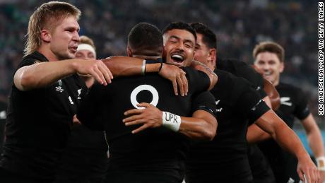 New Zealand&#39;s scrum-half Aaron Smith (C) is hugged by New Zealand&#39;s fly-half Richie Mo&#39;unga (2nd R) after scoring a try during the Japan 2019 Rugby World Cup quarter-final match between New Zealand and Ireland at the Tokyo Stadium in Tokyo on October 19, 2019. (Photo by Odd ANDERSEN / AFP) (Photo by ODD ANDERSEN/AFP via Getty Images)