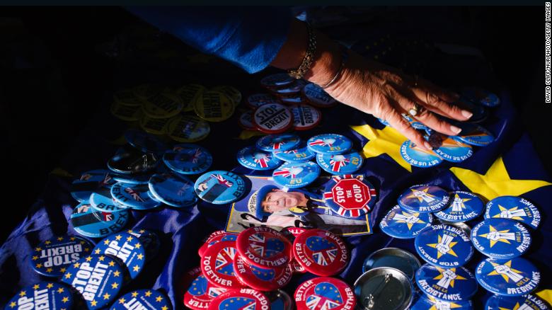 Anti-Brexit buttons rest on a table covered with an EU flag in central London. 