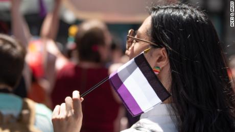 A woman waves the asexual pride flag at WorldPride parade in New York on June 23.