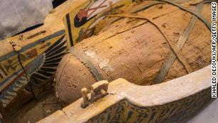 An open coffin displayed in Luxor reveals a mummy.