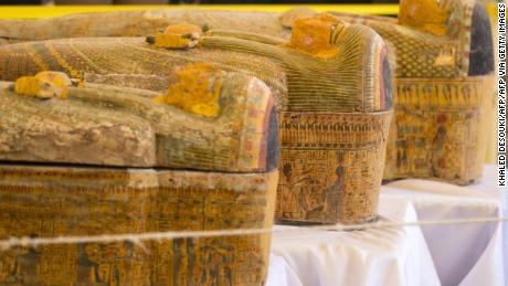 A photograph taken on October 19, 2019 shows sarchophagi displayed in front of Hatshepsut Temple in Egypt&#39;s valley of the Kings in Luxor - Egypt revealed today a rare trove of 30 ancient wooden coffins that have been well-preserved over millennia in the archaeologically rich Valley of the Kings in Luxor.
The antiquities ministry officially unveiled the discovery made at Asasif, a necropolis on the west bank of the Nile River, at a press conference against the backdrop of the Hatshepsut Temple. (Photo by Khaled DESOUKI / AFP) (Photo by KHALED DESOUKI/AFP via Getty Images)