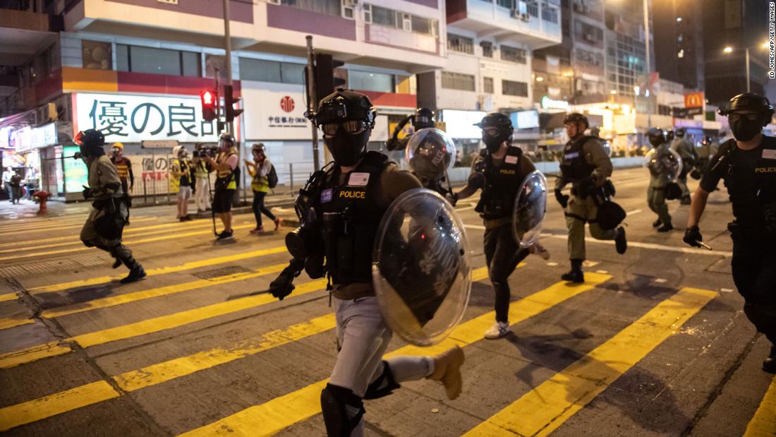 Police charge during a pro-democracy march in the Kowloon district on October 20.