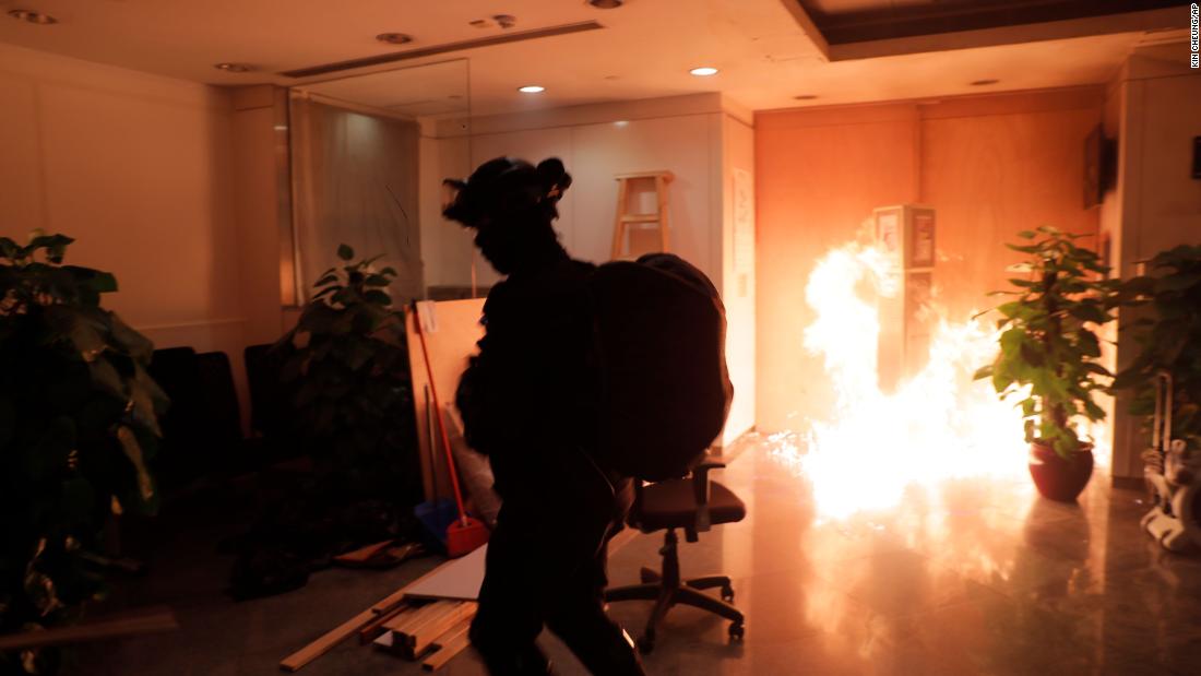 A protester sets fire to a Bank of China branch on October 20.