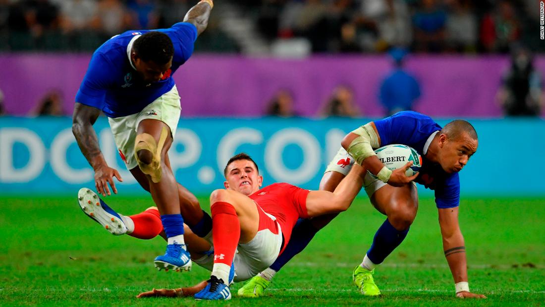 France&#39;s Gael Fickou battles for possession with Wales&#39; Owen Watkin during quarterfinal at Oita Stadium.